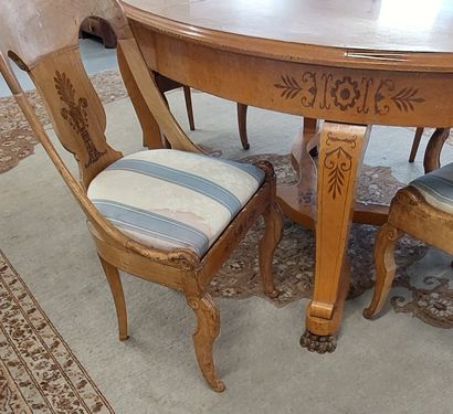 Oval dining room table with light wood struts...