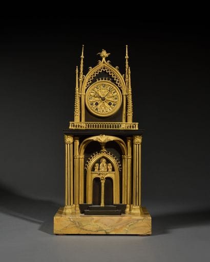 Pendule
en bronze patiné et doré à décor...