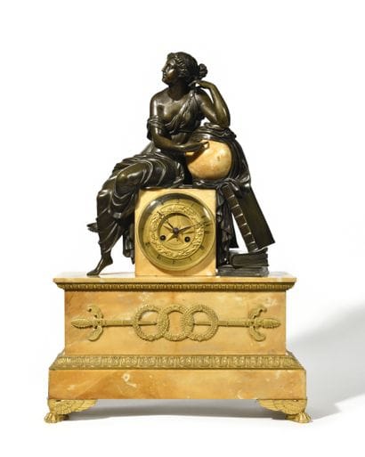 Large clock
in patinated and gilded bronze...