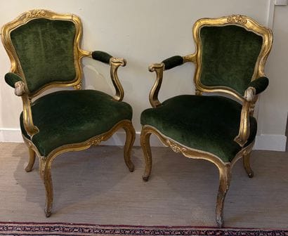 PAIR OF WHEELCHAIRS in molded and gilded...
