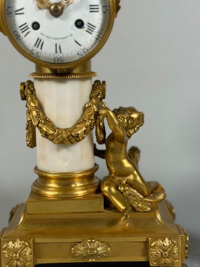 A white marble and gilt-bronze CHIMNEY CLOCK...