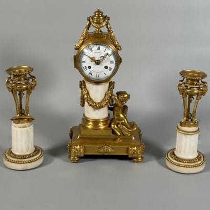 A white marble and gilt-bronze CHIMNEY CLOCK...