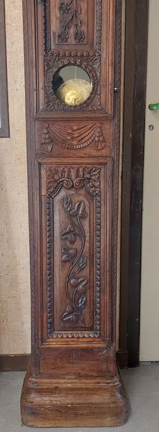 FLOOR CLOCK in moulded and carved oak decorated...