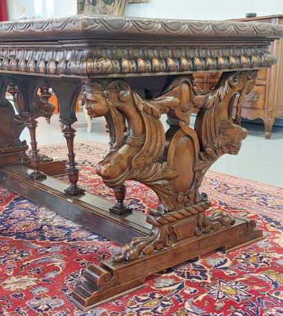 A richly carved walnut midway table opening...