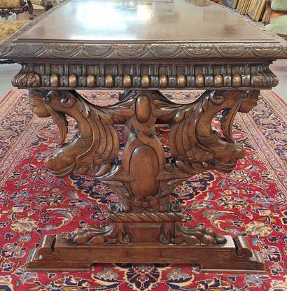 A richly carved walnut midway table opening...