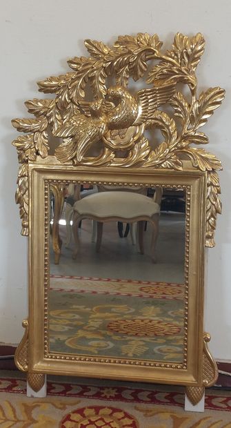 Wood and gilded stucco pediment mirror decorated...