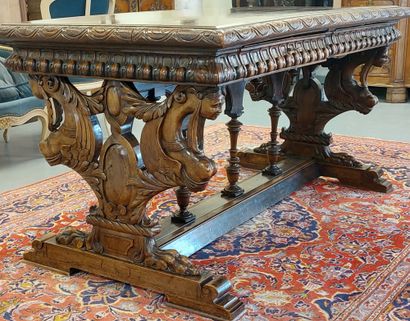 A richly carved walnut midway table opening...