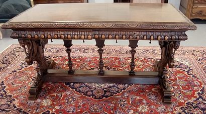 A richly carved walnut midway table opening...