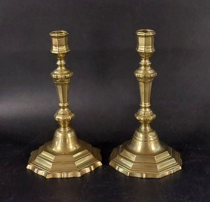 TWO BRONZE CANDLESTICKS, one of which is...
