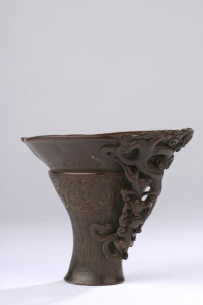 Rhinoceros horn libation cup carved on the...