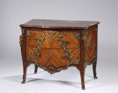 A curved chest of drawers with a slightly...