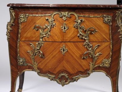 A curved chest of drawers with a slightly...