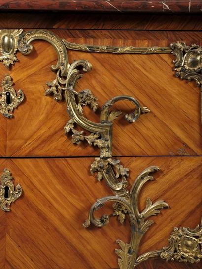 A curved chest of drawers with a slightly...
