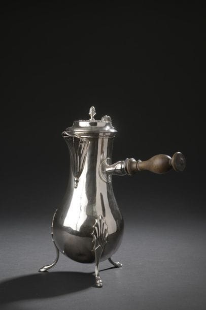 Silver baluster chocolate maker resting on...