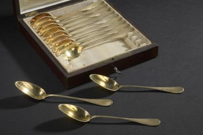 A suite of twelve dessert spoons in vermeil,...