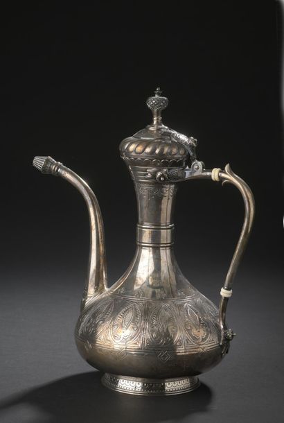 Silver ewer with long neck and slightly flattened...