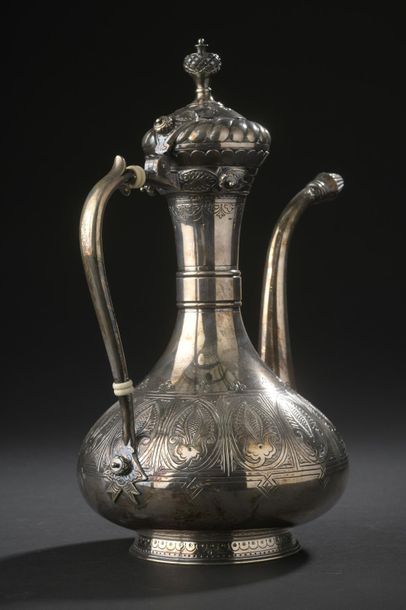 Silver ewer with long neck and slightly flattened...