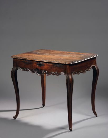 Writing table in walnut, the moulded belt...