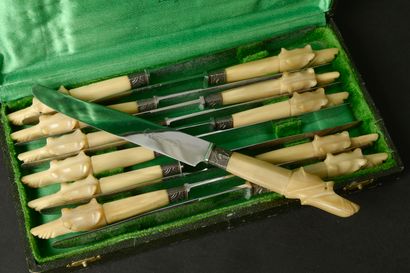 Twelve large knives, the horn handle carved...