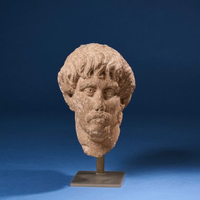 High-relief sculpted head of a moustachioed,...