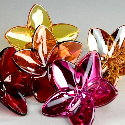 BACCARAT.
Set of five tinted crystal flowers,...