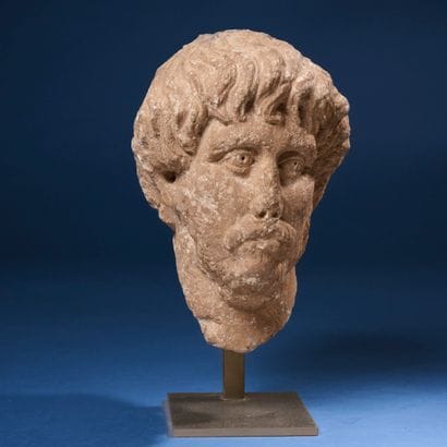 High-relief sculpted head of a moustachioed,...