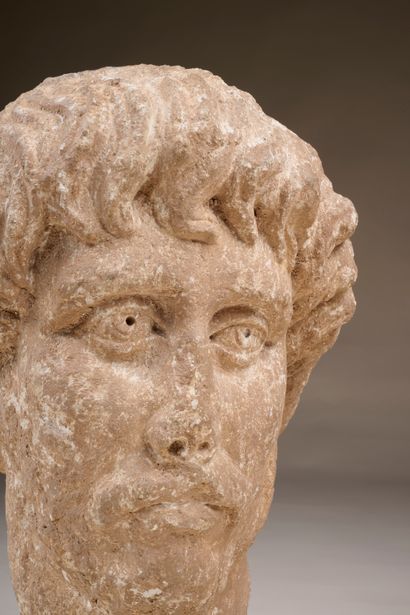 High-relief sculpted head of a moustachioed,...