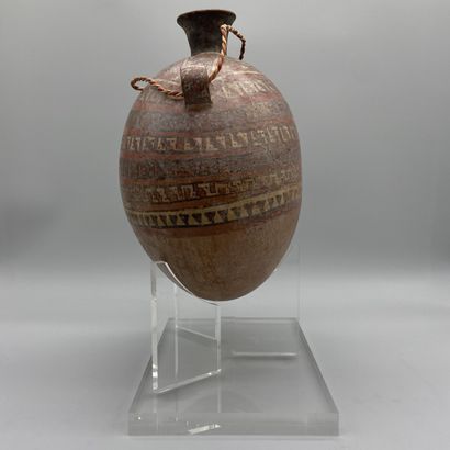 Terracotta flask painted with geometric friezes.
Huari...