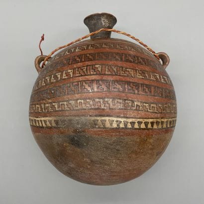 Terracotta flask painted with geometric friezes.
Huari...