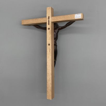 Patinated bronze crucifix mounted on a light...