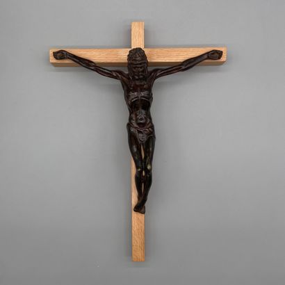 Patinated bronze crucifix mounted on a light...