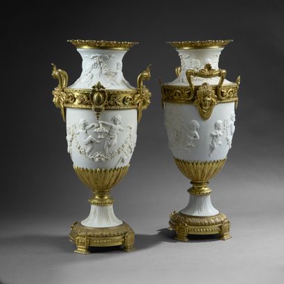 Pair of molded white composition vases decorated...