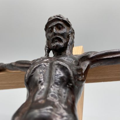 Patinated bronze crucifix mounted on a light...