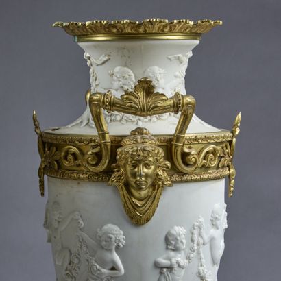 Pair of molded white composition vases decorated...