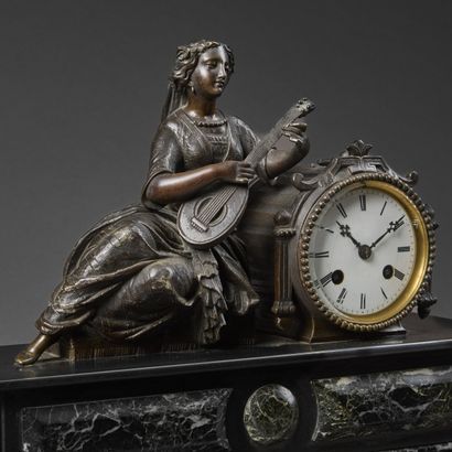 Chased bronze clock with brown patina and...