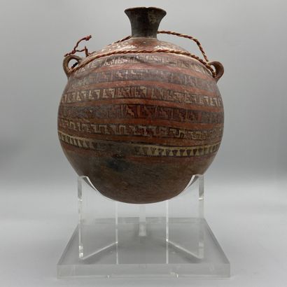 Terracotta flask painted with geometric friezes.
Huari...
