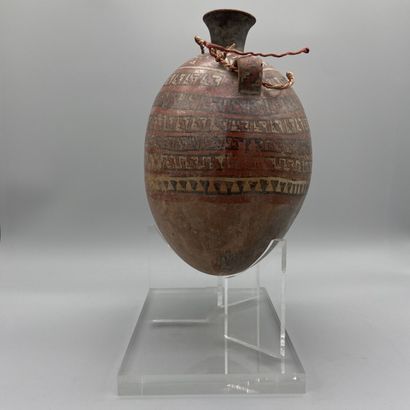 Terracotta flask painted with geometric friezes.
Huari...