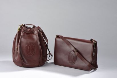 CARTIER

Deux sacs en cuir de veau bordeaux,...
