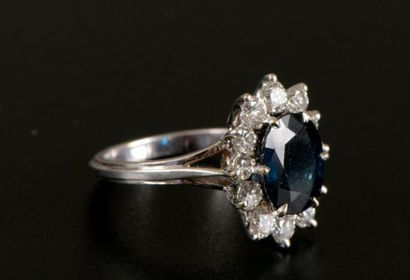 Bague fleur en or gris 18K griffée d'un saphir...