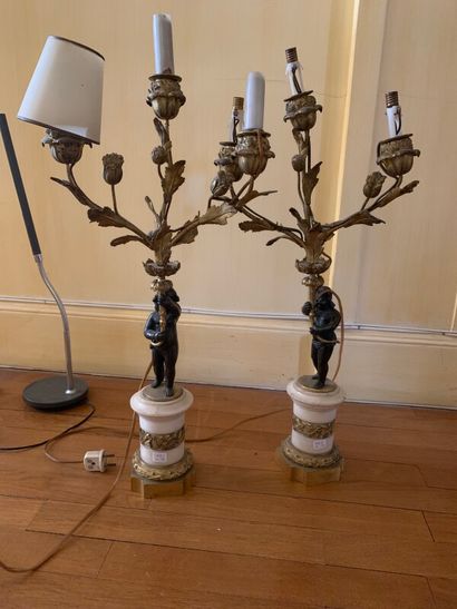 Pair of candelabras in chased and gilded...