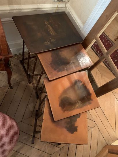 Set of four nesting tables, the tops decorated...
