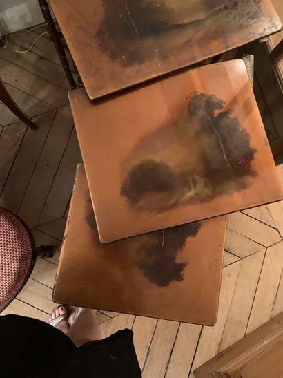 Set of four nesting tables, the tops decorated...