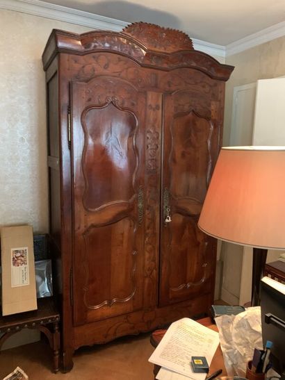 Carved wood cabinet opening with two doors,...