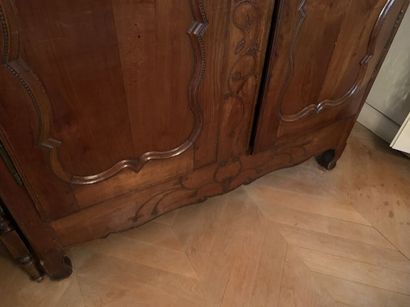 Carved wood cabinet opening with two doors,...