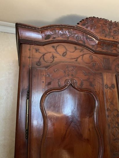 Carved wood cabinet opening with two doors,...