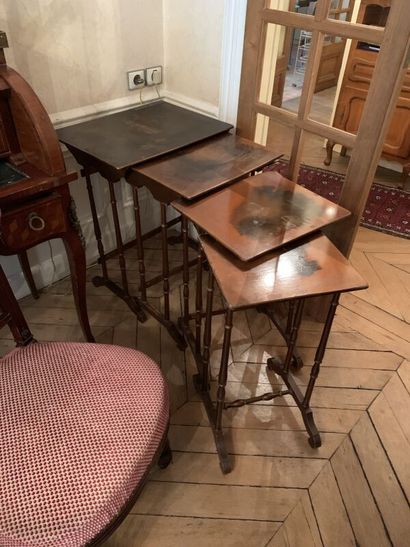 Set of four nesting tables, the tops decorated...