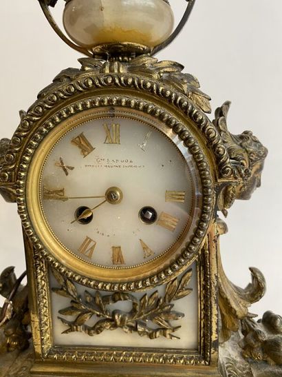 Gilt bronze clock and pair of candlesticks,...