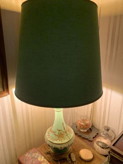 A polychrome enameled porcelain oil lamp...