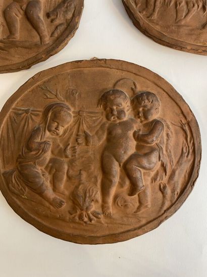 Six terracotta medallions with stamped putti...