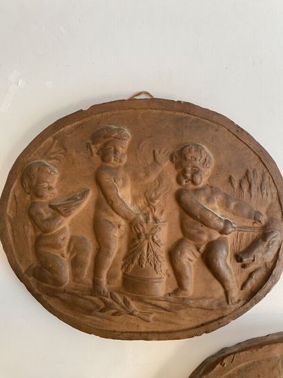 Six terracotta medallions with stamped putti...